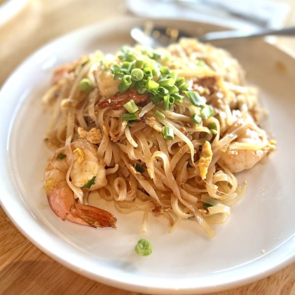 Kin Dee Thai's Pad See Ew with shrimp, noodles, and green onions on a white plate.